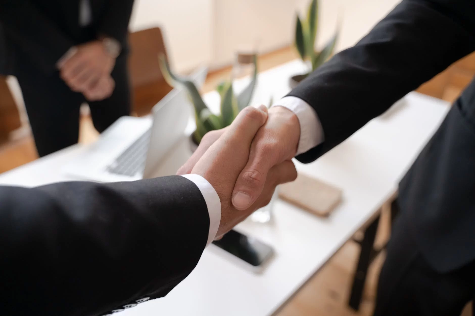 shallow focus of two people handshaking